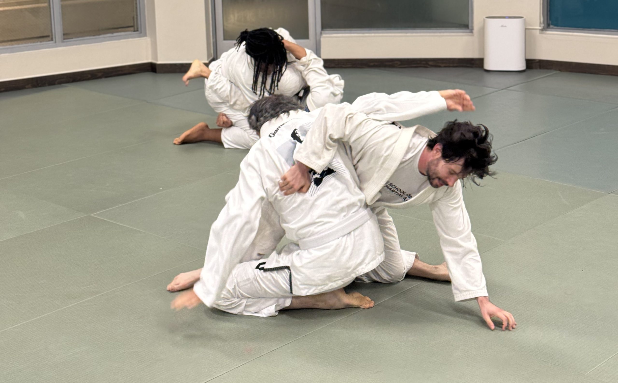 men practicing brazilian jiu jitsu